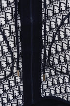 Dior hooded top close-up of navy zip and white Dior monogram pattern