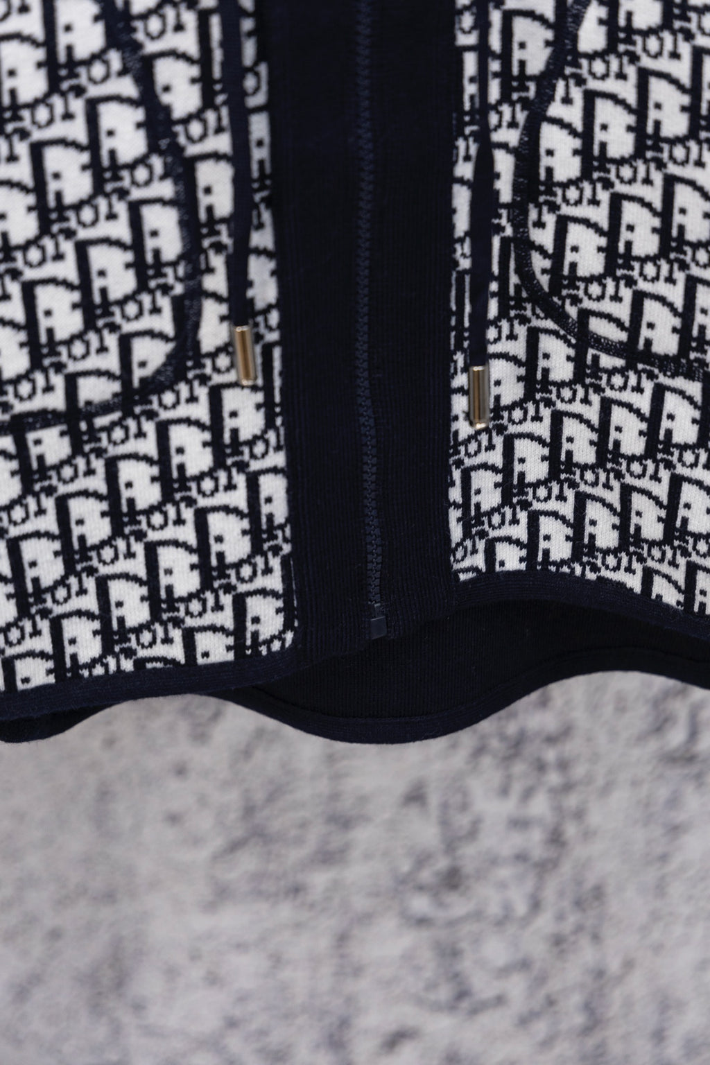 Dior patterned hooded top with navy zipper placket and contrast panel