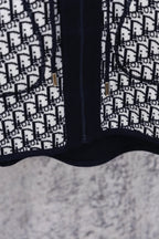 Dior patterned hooded top with navy zipper placket and contrast panel