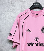 Balenciaga short-sleeve T-shirt, pink close-up of sleeve seam and chest logo