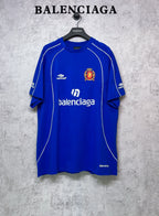 Blue short-sleeve jersey top with white piping and crest on chest
