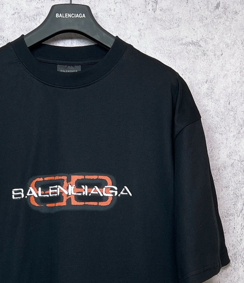 Balenciaga black short-sleeve T-shirt with orange-outlined logo graphic detail