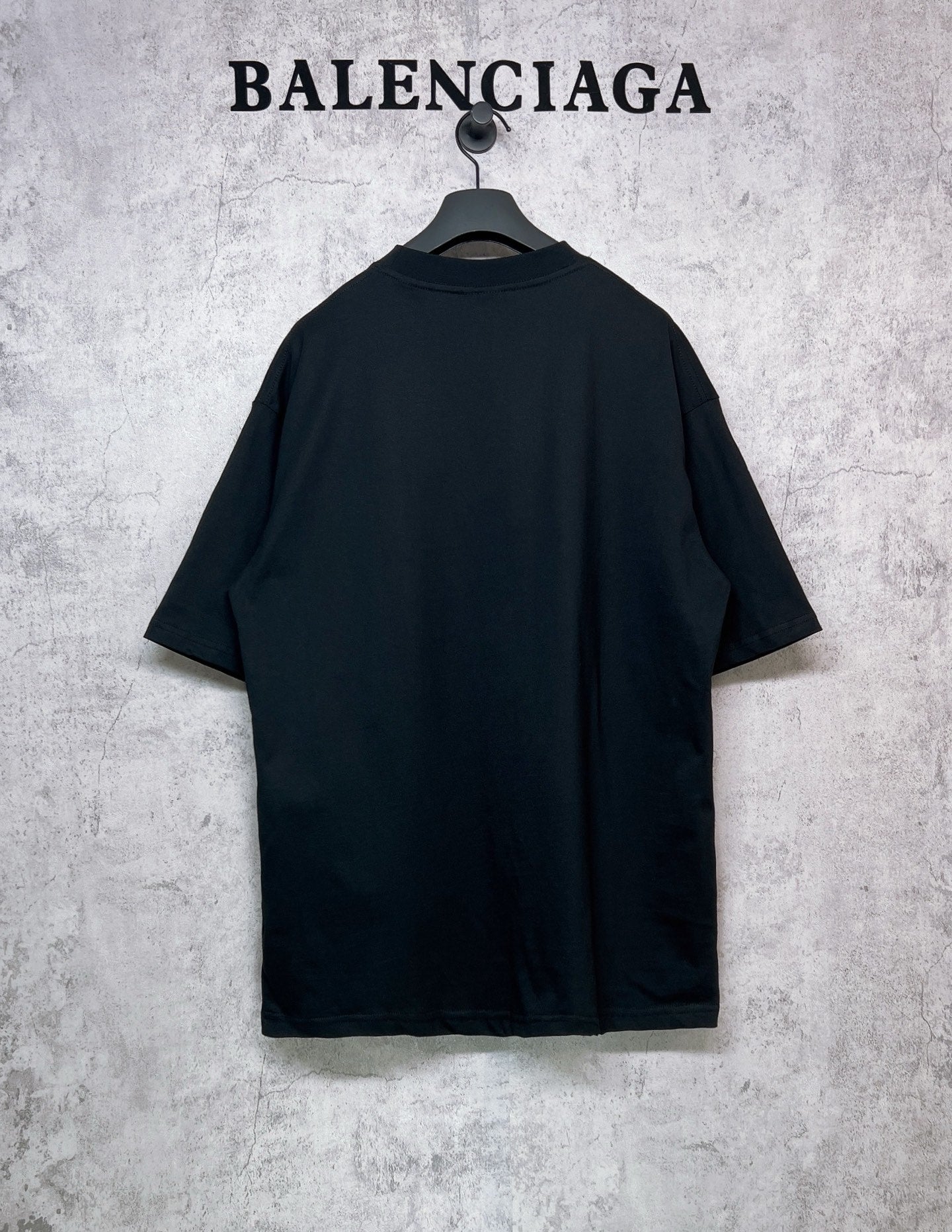 Balenciaga black short-sleeve T-shirt, back view, hanging on a hanger