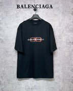 Balenciaga black short-sleeve T-shirt with orange and white logo graphic on chest