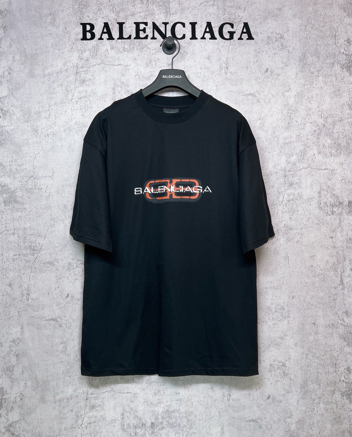 Balenciaga black short-sleeve T-shirt with orange and white logo graphic on chest