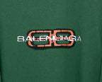 Close-up of Balenciaga logo print on green T-shirt