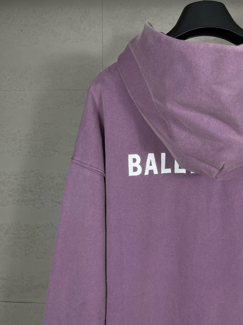 Purple long hoodie with adjustable hood and partial back BALENCIAGA logo lettering.