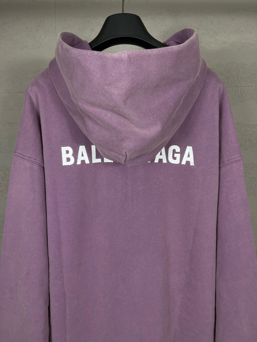 Purple long hoodie with adjustable hood and large back BALENCIAGA logo text.