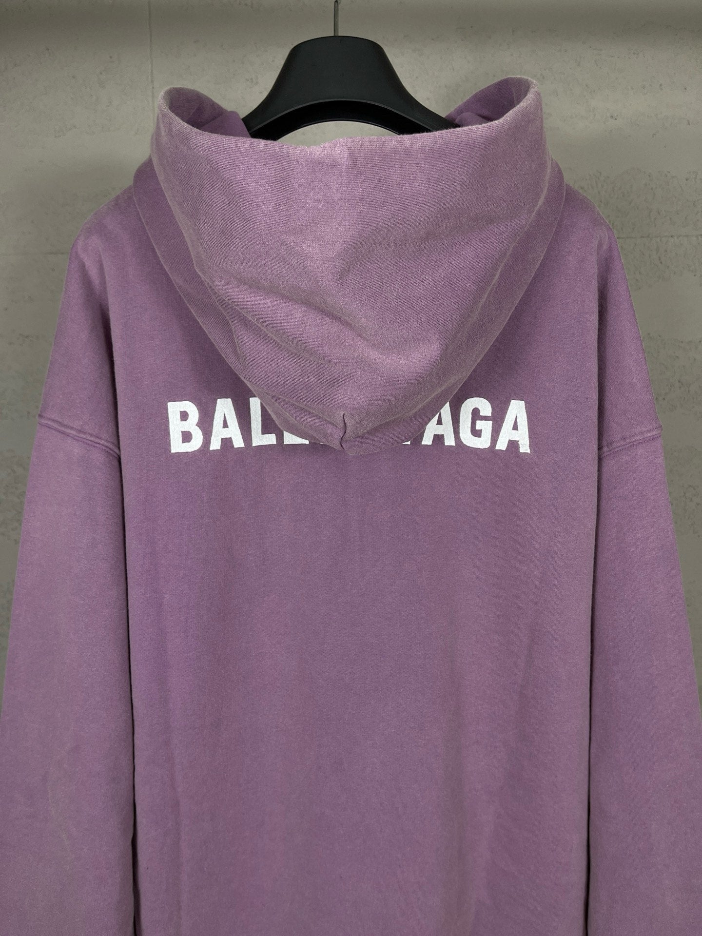 Purple long hoodie with adjustable hood and large back BALENCIAGA logo text.