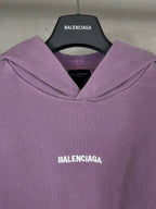 Purple long hoodie with adjustable hood and centered chest BALENCIAGA logo.