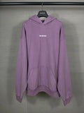 Purple long hoodie with adjustable hood, kangaroo pocket, and BALENCIAGA logo on chest.