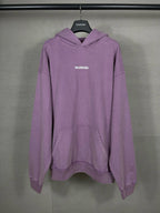 Purple long hoodie with adjustable hood, kangaroo pocket, and BALENCIAGA logo on chest.