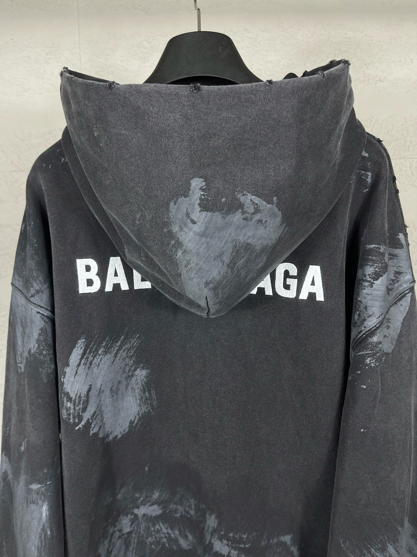 Balenciaga pullover hoodie back view with hood, distressed print and large logo text