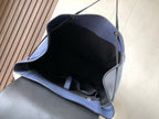 Open blue leather backpack interior with black lining and inner strap