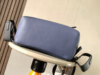 Blue leather zip pouch with crossbody strap and black trim handle loops