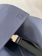 Loewe logo emboss on blue leather flap with metal clasp and strap