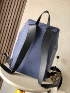 Blue leather backpack with wide straps and front flap pocket