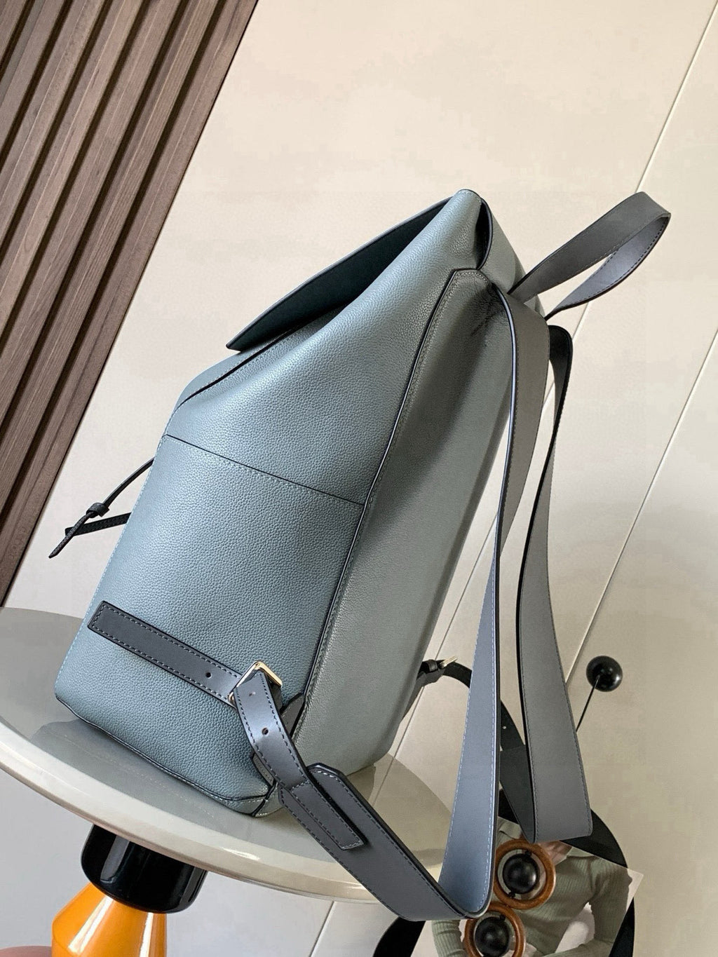 Loewe men's leather backpack with top flap, adjustable straps, and zip pocket