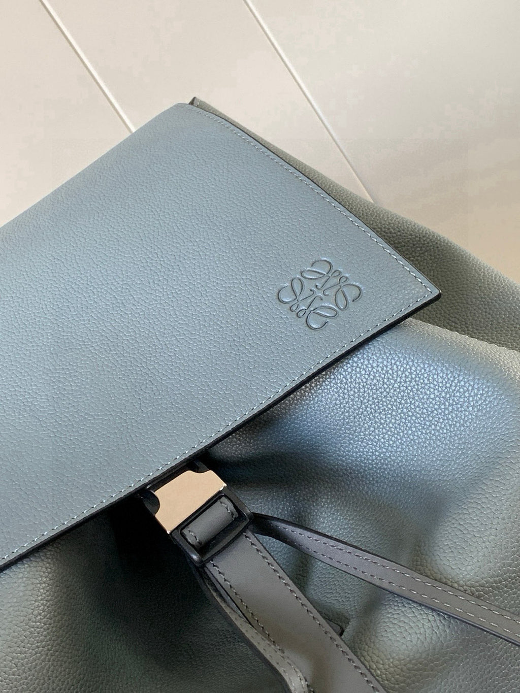Loewe men's leather backpack flap with embossed LOEWE logo
