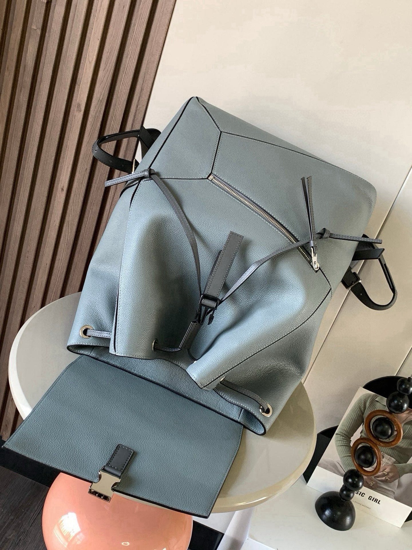 Loewe men's leather backpack with front zip pocket and drawstring strap details