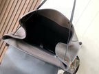 Light gray leather backpack interior view with open top and side pockets