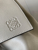 Loewe men’s bag logo detail, metallic gray embossed emblem on leather panel