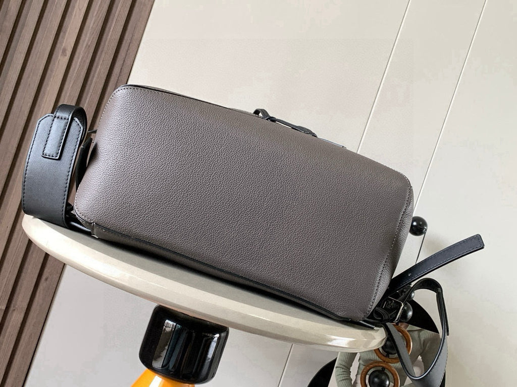 Light gray leather backpack with top zip and drawstring cords, side straps visible