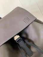 Loewe men’s bag detail, metallic gray leather with embossed logo and inner strap