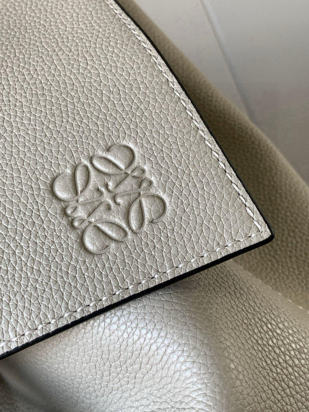 Loewe men's bag leather patch with embossed floral logo on cream pebble grain