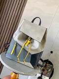 Loewe bag with light and dark panels, flap front, top handle, and yellow drawstring ties