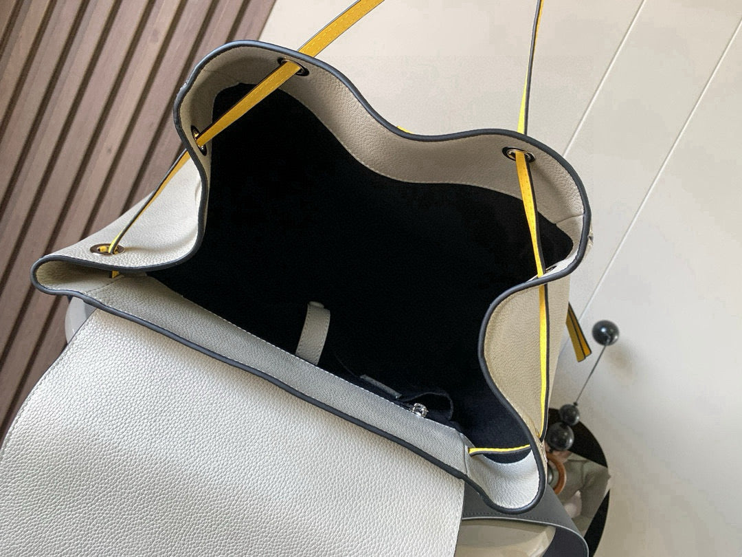 Loewe men's bag interior showing black lining and cream edge with yellow cords