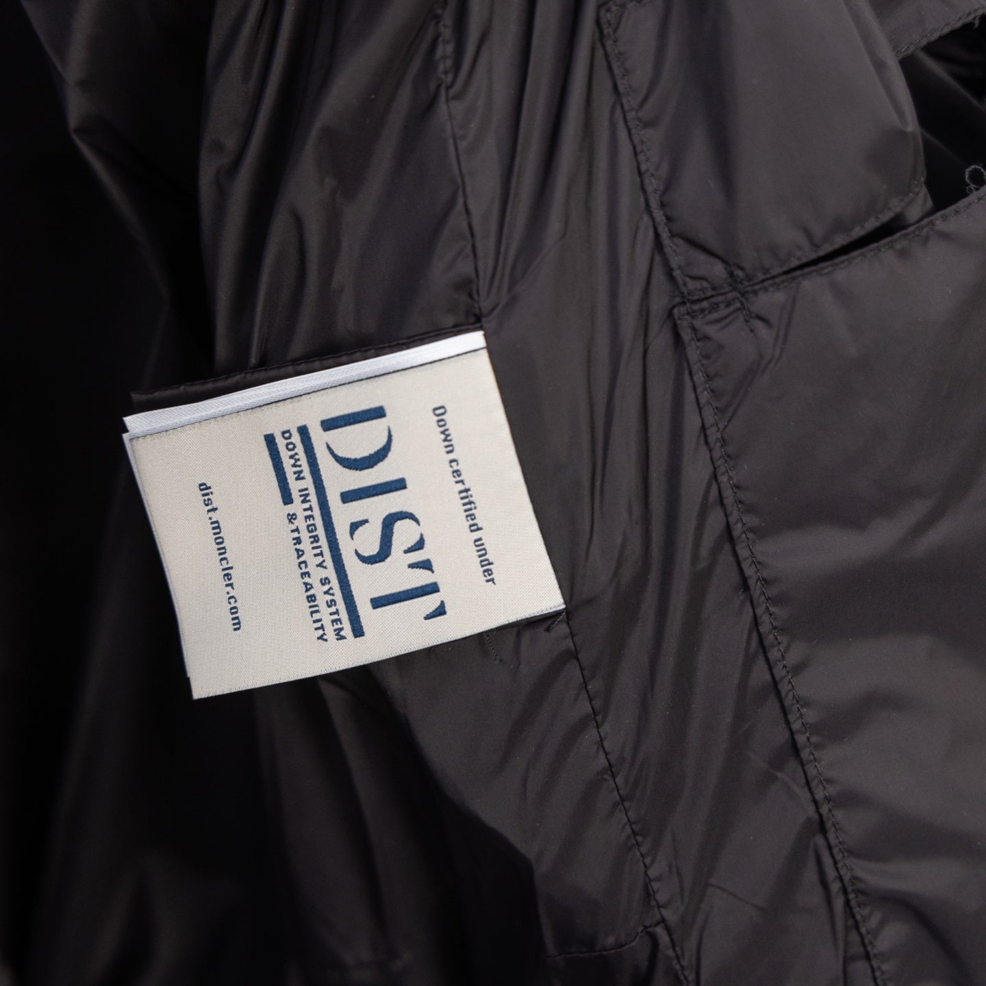 Moncler long puffer jacket label on inner chest