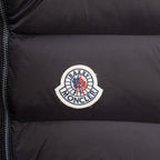 Moncler circular logo patch on black puffer vest fabric