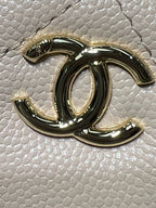 Gold-tone Chanel logo charm on textured light leather