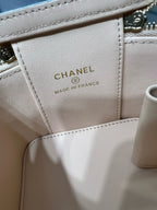 Light beige leather bag label reading CHANEL and MADE IN FRANCE