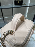 Light beige mini handbag with top handle and gold-tone chain strap hardware