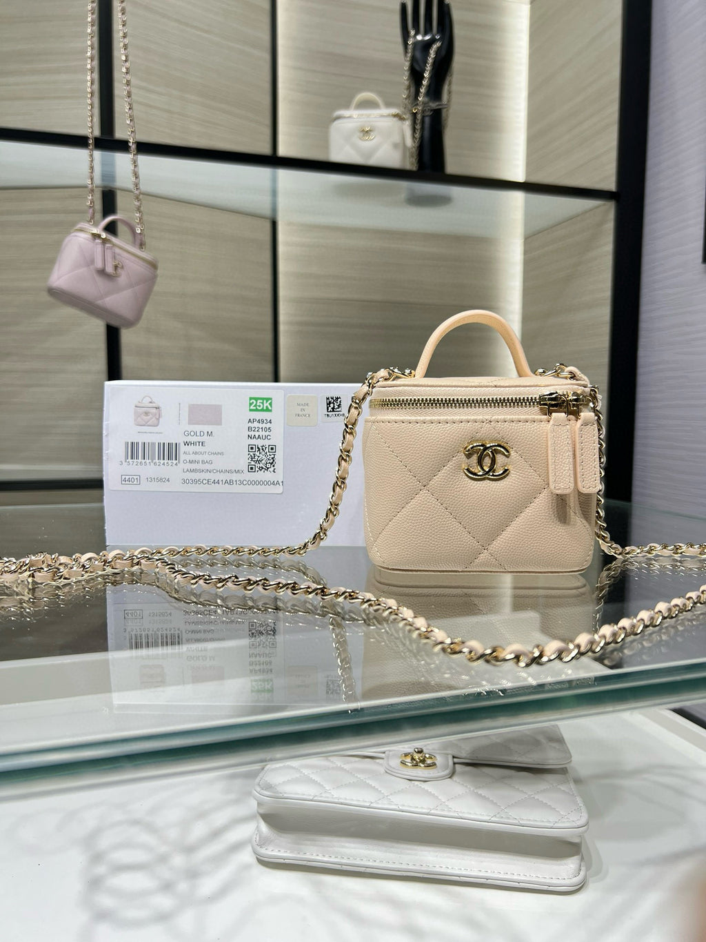 Small quilted leather top-handle bag with gold chain strap and clasp hardware