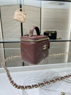 Maroon textured mini handbag with top handle and gold chain strap