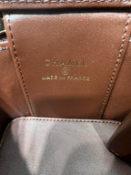 Tan leather bag panel with embossed CHANEL and MADE IN FRANCE text