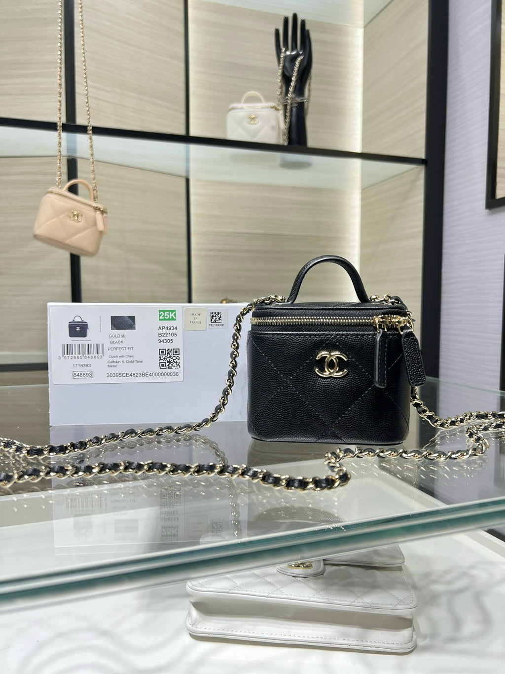 Black mini quilted leather bag with gold chain strap and top handle, CC emblem