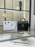 Black mini quilted leather bag with gold chain strap and top handle, CC emblem