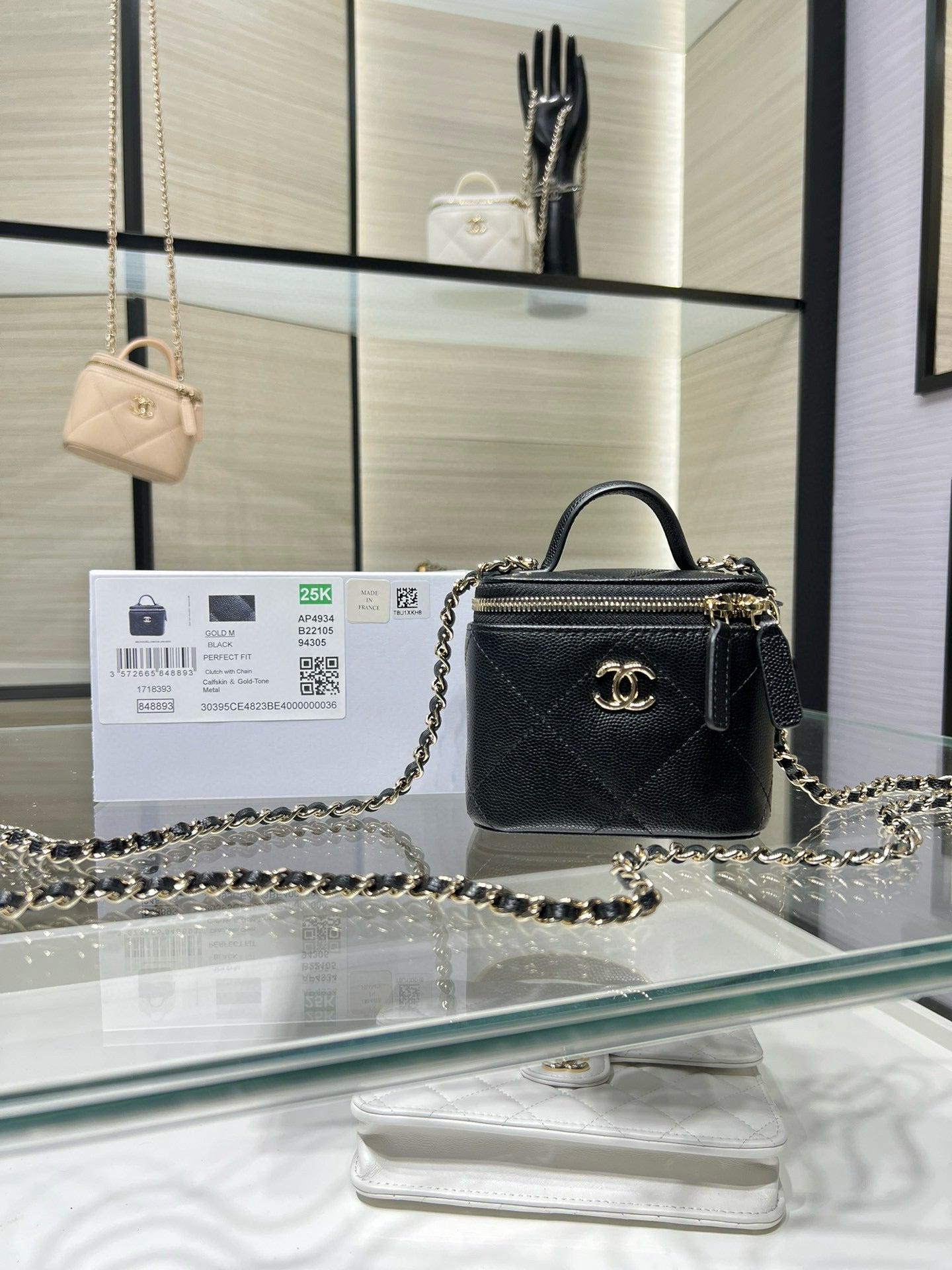 Black mini quilted leather bag with gold chain strap and top handle, CC emblem