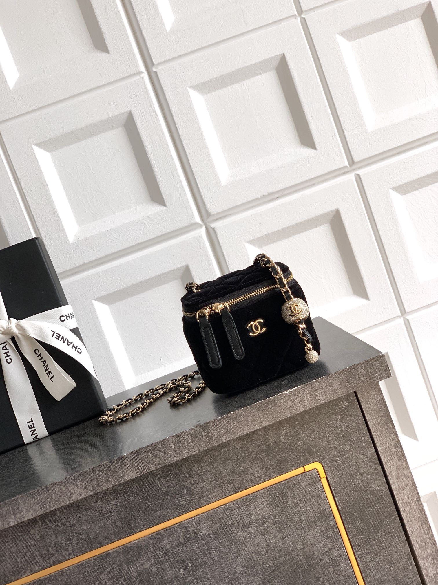 Black Chanel quilted mini crossbody bag with chain strap and gold-tone clasp