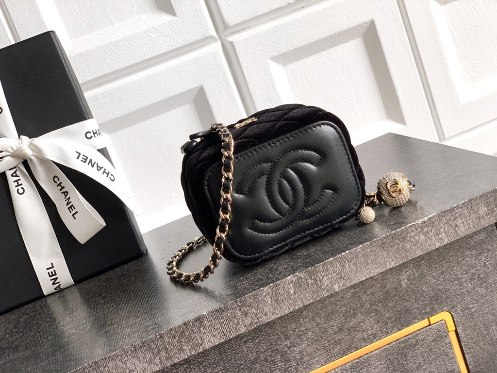 Black Chanel quilted camera-style bag with chain strap and CC turn-lock
