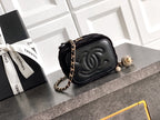 Black Chanel quilted camera-style bag with chain strap and CC turn-lock