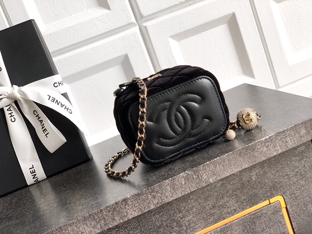 Black Chanel quilted camera-style bag with chain strap and CC turn-lock