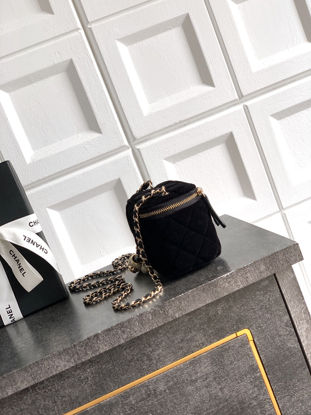 Black Chanel quilted mini bag with chain strap and gold zipper pull