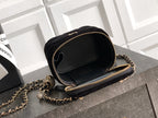 Black Chanel round mini crossbody bag with chain strap and gold zipper