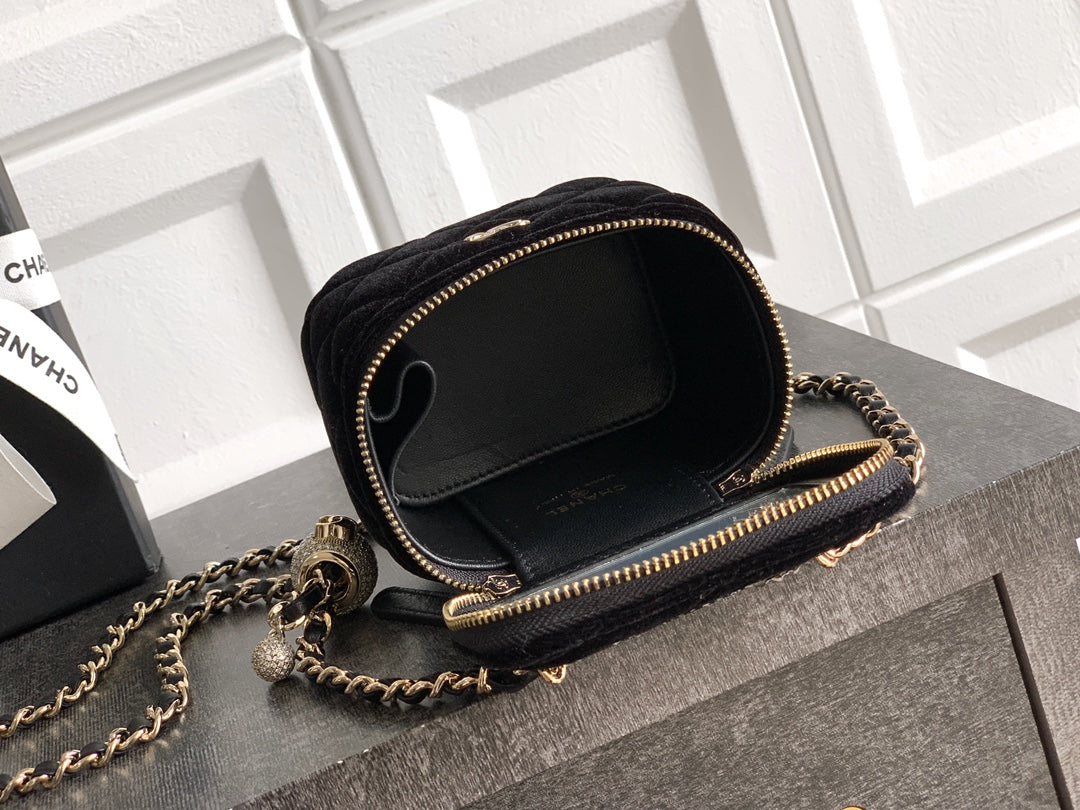 Black Chanel round mini crossbody bag with chain strap and gold zipper