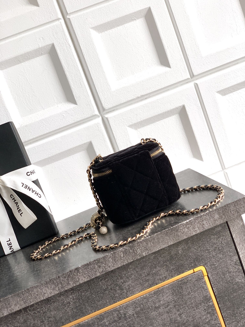 Black Chanel quilted mini crossbody bag with gold zipper and chain strap